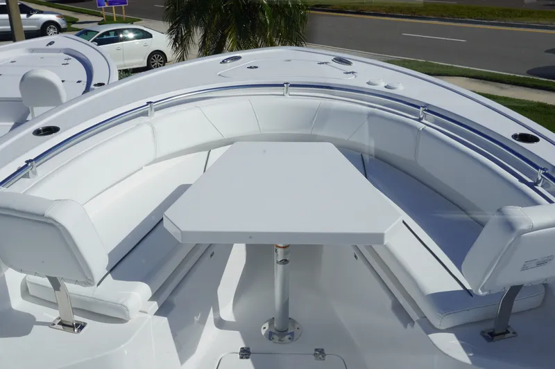 Slide: The Image of 2027 Sportsman Open 232 Center Console boat with white seating and table setup. - 19