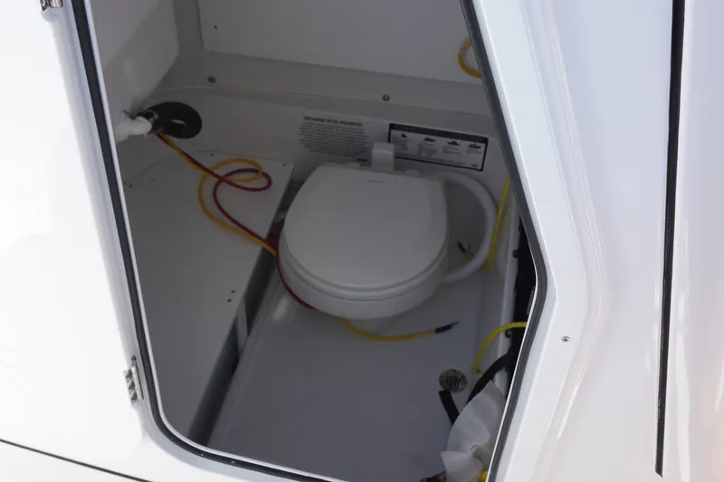 Slide: The Image of 2027 Sportsman Open 232 Center Console boat interior with marine toilet. - 22