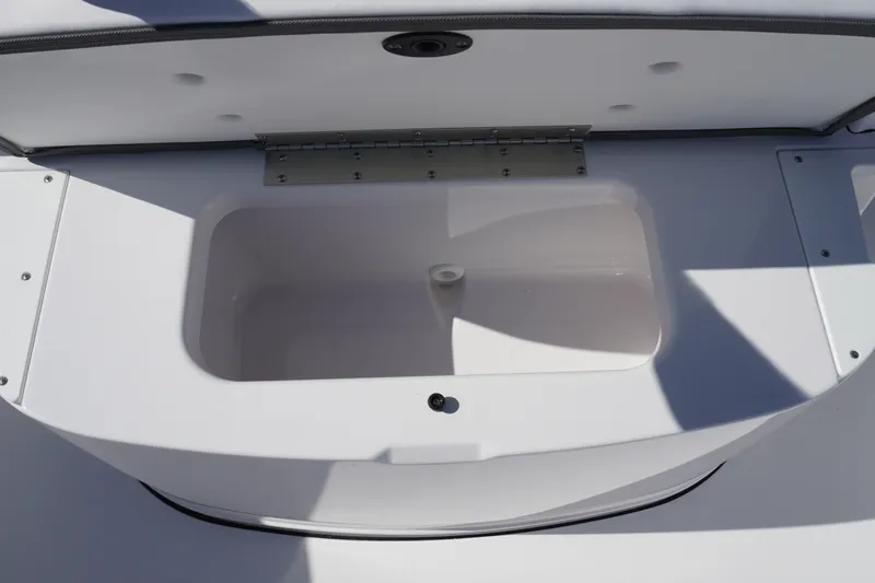 Slide: The Image of Open storage compartment on 2027 Sportsman Open 232 Center Console boat. - 21