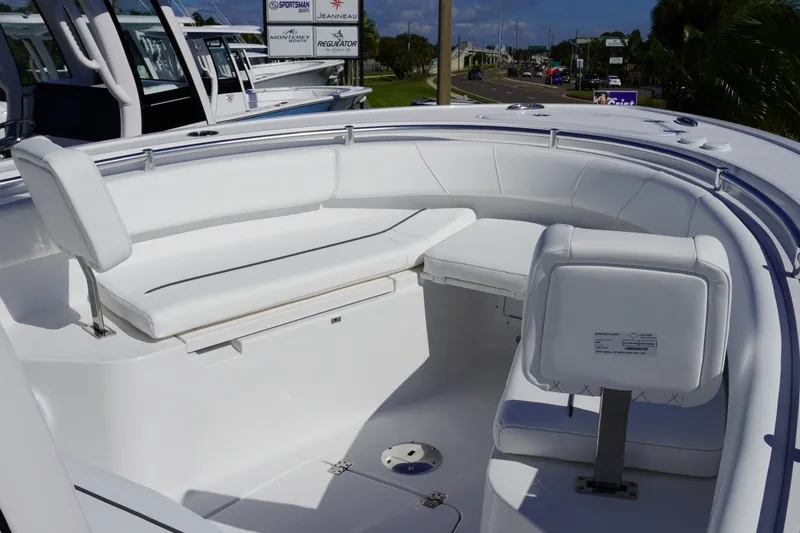 Slide: The Image of 2027 Sportsman Open 232 Center Console boat with white seating and sleek design. - 14
