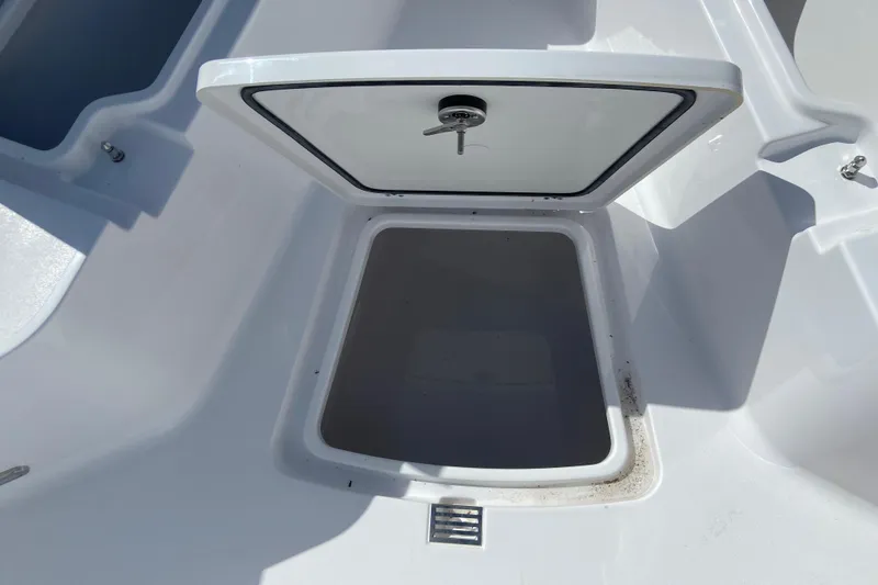 Slide: The Image of Open storage compartment on a 2027 Sportsman Open 232 Center Console boat. - 20