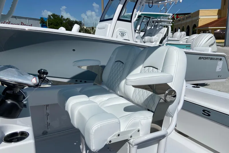 Slide: The Image of 2027 Sportsman Open 232 Center Console boat with luxurious white seating and modern design. - 17