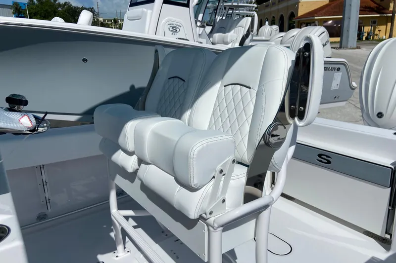 Slide: The Image of 2027 Sportsman Open 232 Center Console boat with luxurious white seating and modern design. - 16