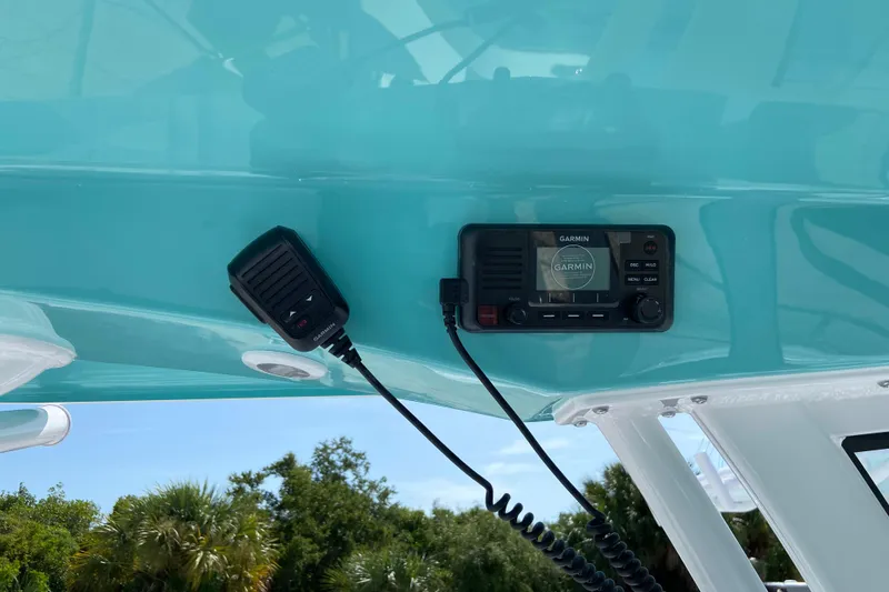 Slide: The Image of Garmin radio system on 2027 Sportsman Open 232 Center Console boat, turquoise interior. - 15
