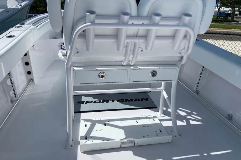 Slide: The Image of 2027 Sportsman Open 232 Center Console boat interior with rod holders and storage drawers. - 6