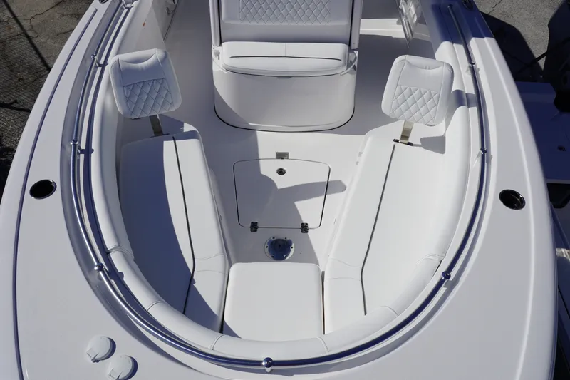 Slide: The Image of 2027 Sportsman Open 232 Center Console boat interior with white seating and storage. - 15