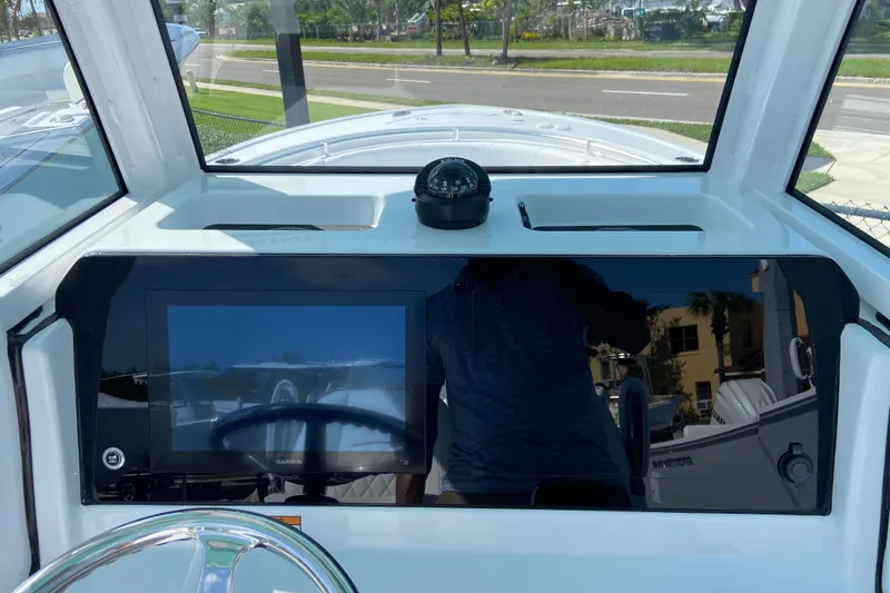 Slide: The Image of 2027 Sportsman Open 232 Center Console dashboard with navigation display and compass. - 14