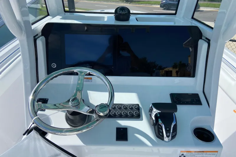 Slide: The Image of 2027 Sportsman Open 232 Center Console dashboard with steering wheel and controls. - 12