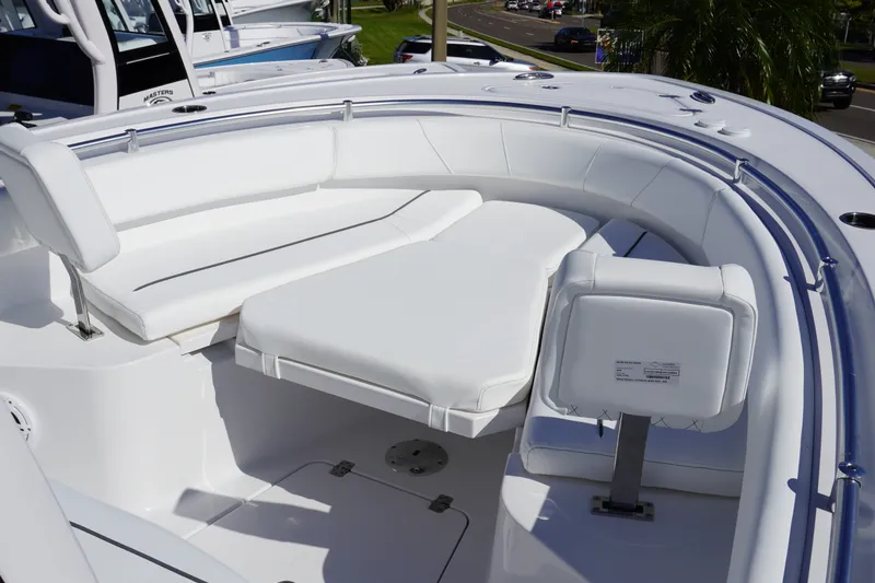 Slide: The Image of 2027 Sportsman Open 232 Center Console boat with white cushioned seating. - 16