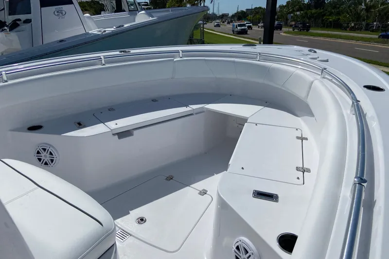 Slide: The Image of 2027 Sportsman Open 232 Center Console boat interior with seating and storage compartments. - 18