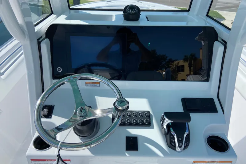 Slide: The Image of 2027 Sportsman Open 232 Center Console dashboard with steering wheel and controls. - 11