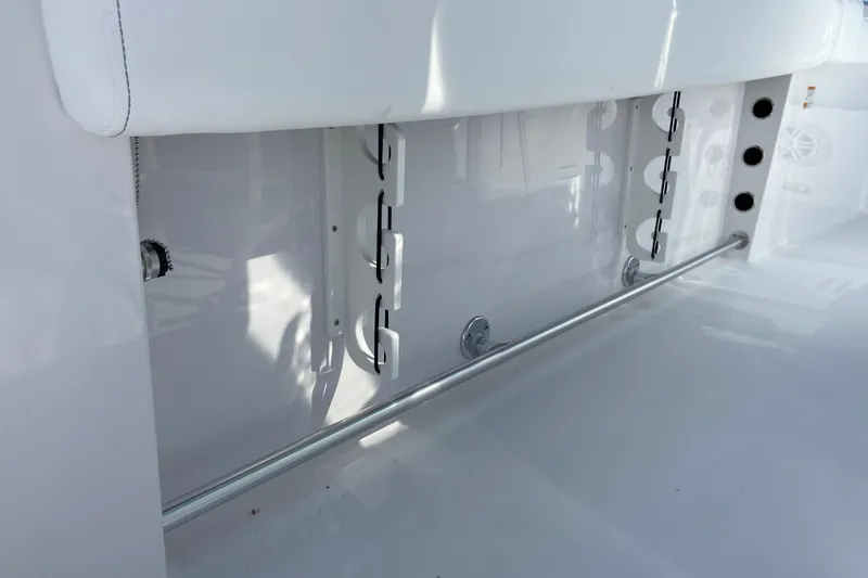 Slide: The Image of 2027 Sportsman Open 232 Center Console boat interior detail, featuring rod holders and sleek design. - 9