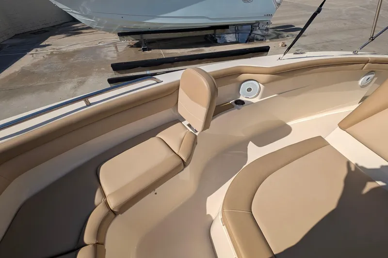 Slide: The Image of 2019 Scout 215 XSF boat interior with beige seating and cup holders. - 32