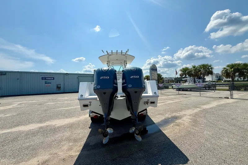 Slide: The Image of 2007 Regulator 29 Forward Seating boat with twin Yamaha 250 engines, parked outdoors. - 3