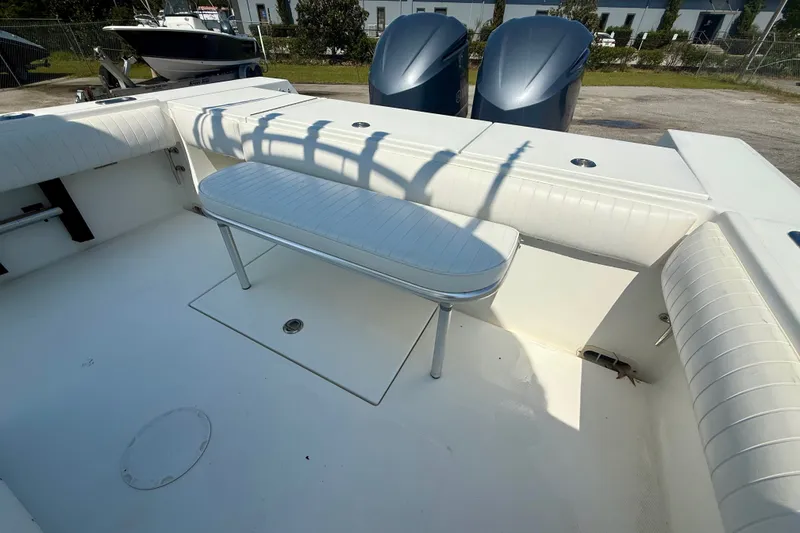 Slide: The Image of 2007 Regulator 29 Forward Seating boat interior with white cushioned seating and dual engines. - 10