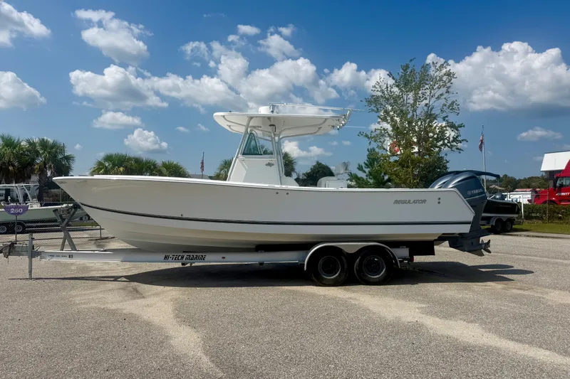 Slide: The Image of 2007 Regulator 29 Forward Seating boat on trailer under blue sky. - 1
