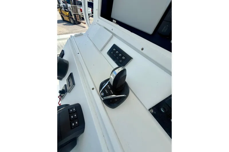 Slide: The Image of 2007 Regulator 29 Forward Seating boat control panel with joystick and switches. - 18