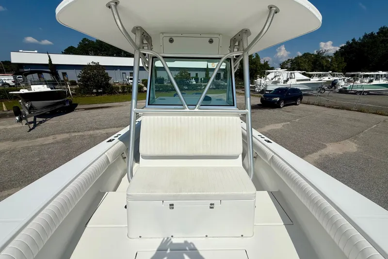Slide: The Image of 2007 Regulator 29 Forward Seating boat with white interior, parked outdoors. - 21