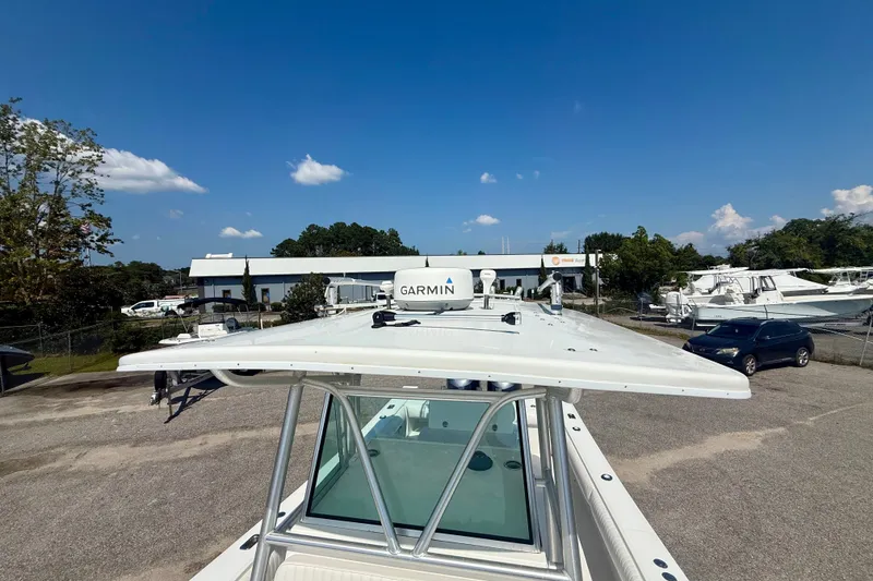 Slide: The Image of 2007 Regulator 29 Forward Seating boat with Garmin equipment, parked outdoors under a clear blue sky. - 22