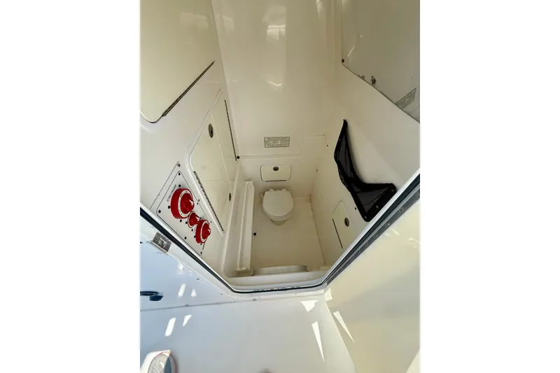 Slide: The Image of 2007 Regulator 29 Forward Seating boat interior with toilet and control panel. - 19