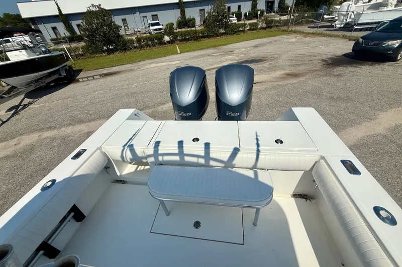 Slide: The Image of 2007 Regulator 29 Forward Seating boat with twin 250 engines, parked outdoors. - 9