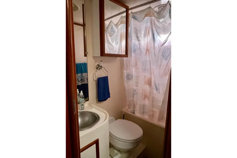 Slide: The Image of Compact bathroom in a 1985 CHB 42 boat with shower and sink. - 55