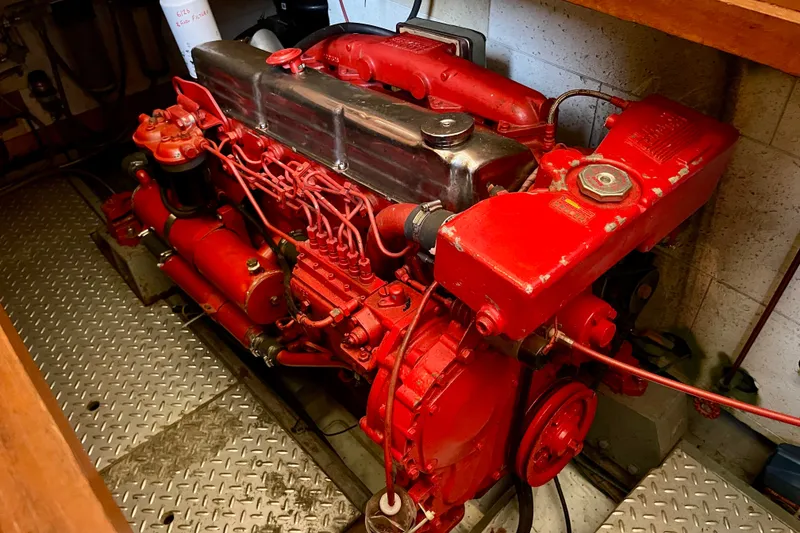 Slide: The Image of Red engine of a 1985 CHB 42 boat, showcasing intricate mechanical components. - 60
