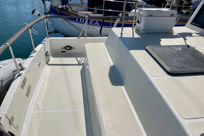 Slide: The Image of 1985 CHB 42 boat deck with seating, docked near water. - 10