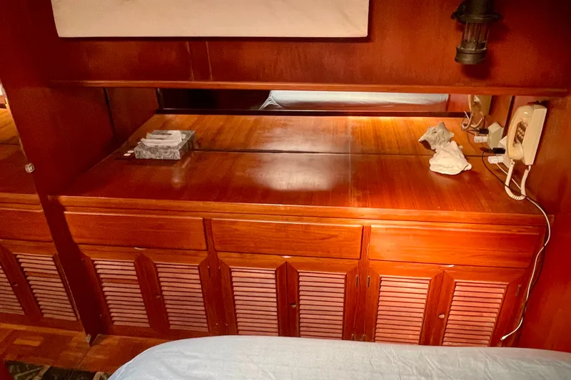 Slide: The Image of Wooden interior of 1985 CHB 42 boat with cabinets and vintage phone. - 59