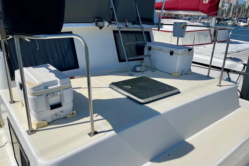 Slide: The Image of 1985 CHB 42 yacht deck with coolers and marina view. - 13