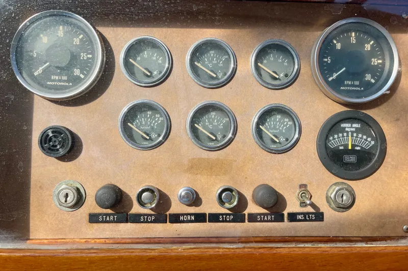 Slide: The Image of Dashboard of a 1985 CHB 42 boat with gauges and control switches. - 20