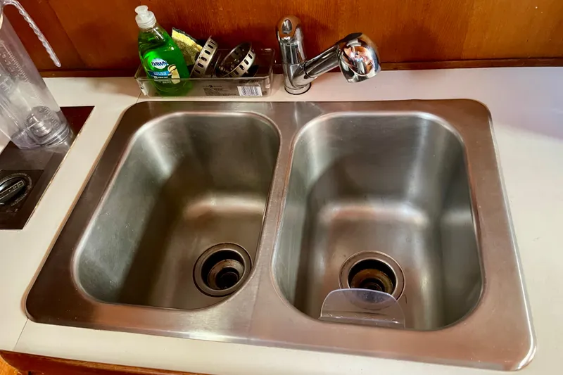 Slide: The Image of Double stainless steel sink with faucet and dish soap on a CHB 42, 1985 model. - 43