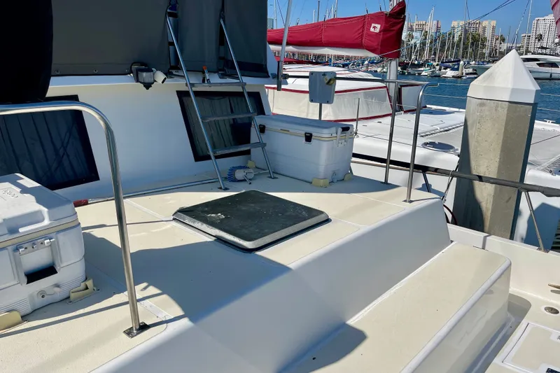 Slide: The Image of 1985 CHB 42 yacht deck with coolers, ladder, and marina view. - 14