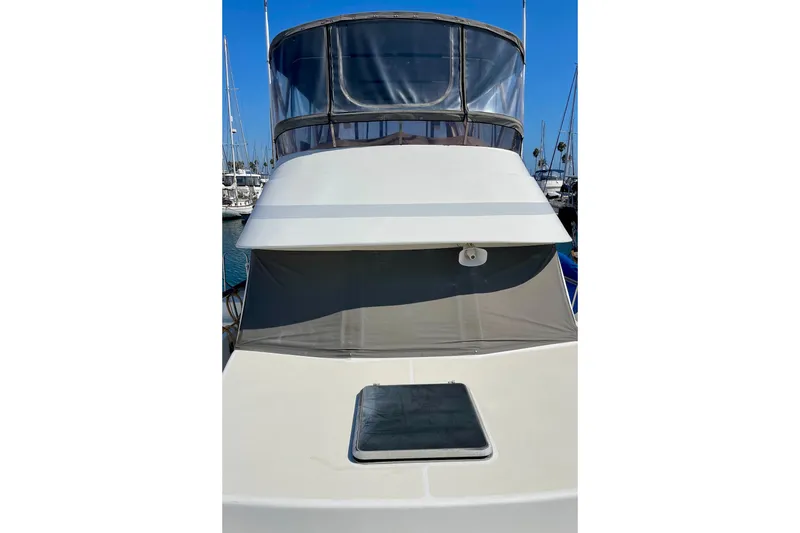 Slide: The Image of 1985 CHB 42 yacht with flybridge, docked in marina under clear blue sky. - 5