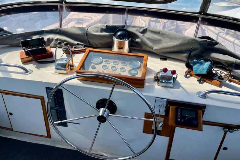 Slide: The Image of Helm of a 1985 CHB 42 boat with navigation instruments and steering wheel. - 18