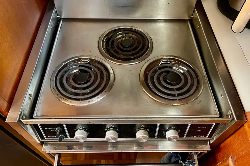 Slide: The Image of Vintage 1985 CHB 42 stove with three electric burners and control knobs. - 42