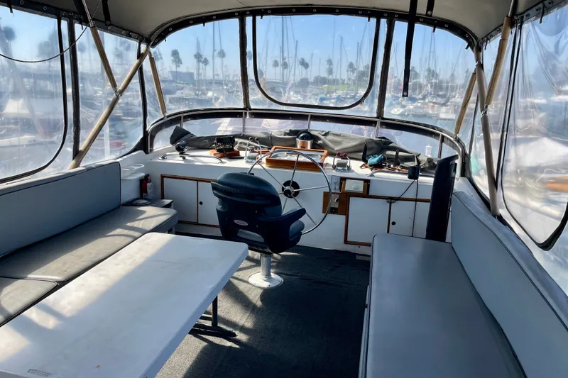 Slide: The Image of Interior view of a 1985 CHB 42 boat with seating and steering wheel. - 15