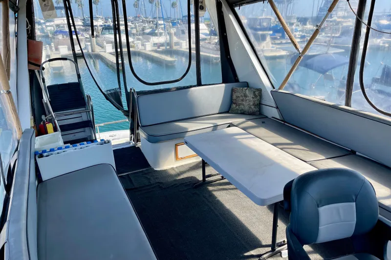 Slide: The Image of Interior of 1985 CHB 42 boat with seating, table, and marina view. - 16