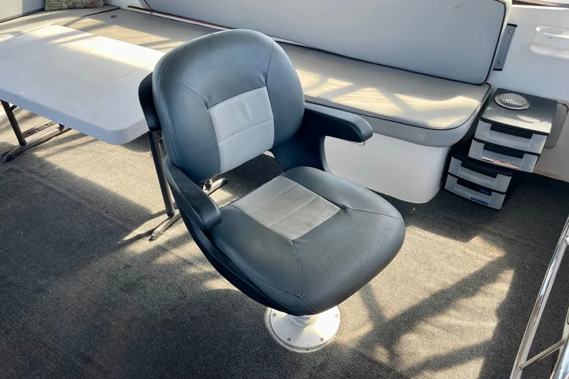 Slide: The Image of Captain's chair on 1985 CHB 42 boat, with table and seating area. - 17