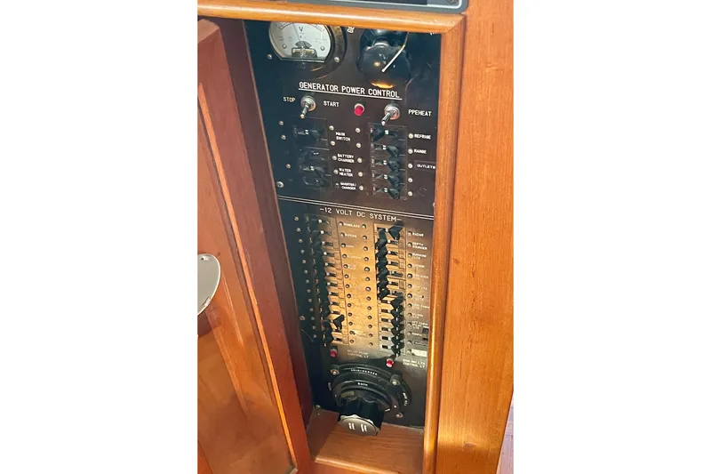 Slide: The Image of Electrical control panel on a 1985 CHB 42 boat, featuring generator and 12-volt DC system. - 34