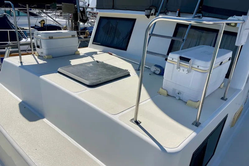 Slide: The Image of 1985 CHB 42 boat deck with coolers and railing in a marina setting. - 9
