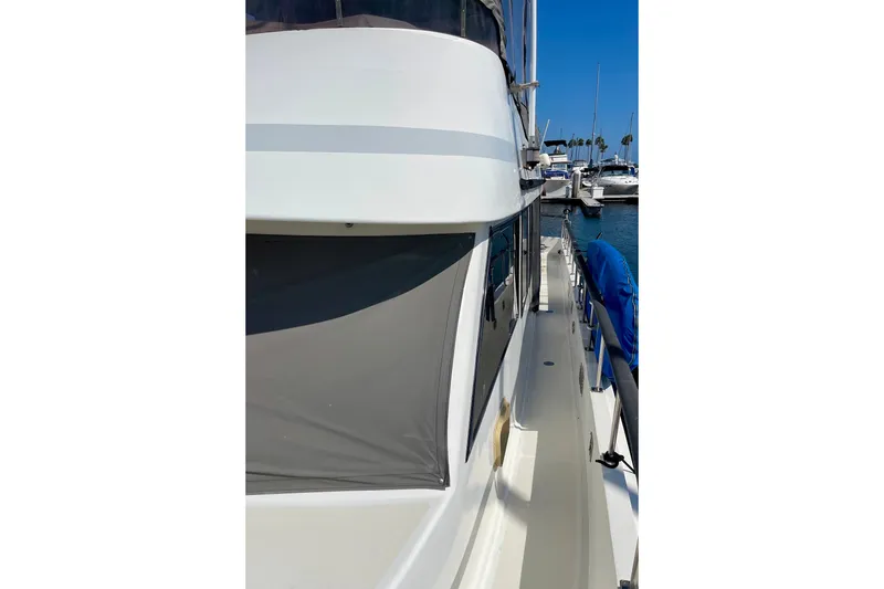 Slide: The Image of 1985 CHB 42 yacht docked at marina, side view with clear blue sky. - 7