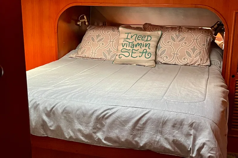 Slide: The Image of Cozy cabin bed in 1985 CHB 42 boat with decorative pillows. - 52