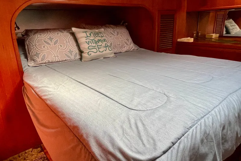 Slide: The Image of Cozy bedroom in 1985 CHB 42 boat with decorative pillows and wooden interior. - 56