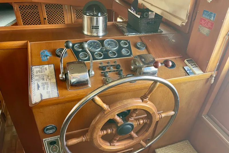 Slide: The Image of Wooden helm of a 1985 CHB 42 boat with gauges and controls. - 29