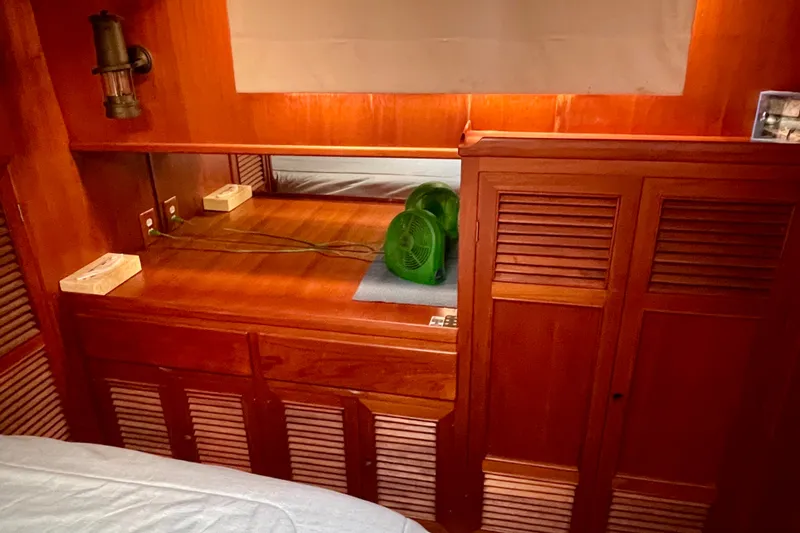 Slide: The Image of Wooden interior of 1985 CHB 42 boat cabin with fan and storage cabinets. - 57