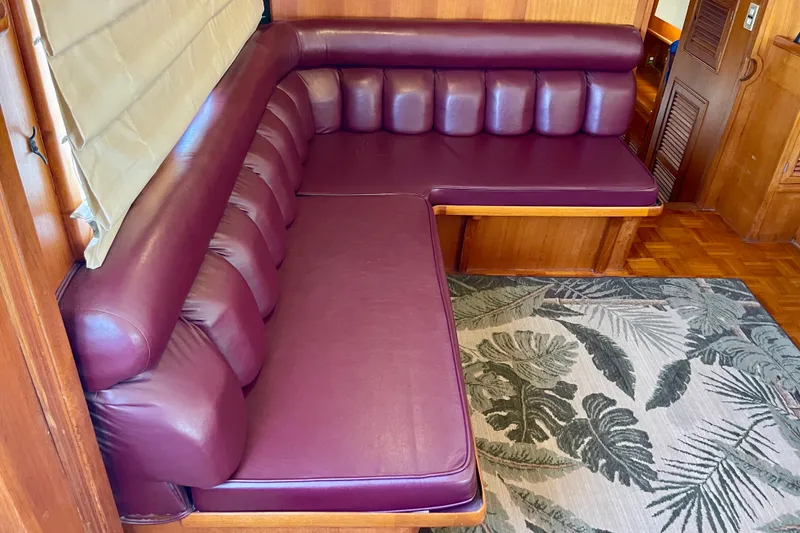 Slide: The Image of Luxurious maroon leather seating in a 1985 CHB 42 yacht interior. - 24