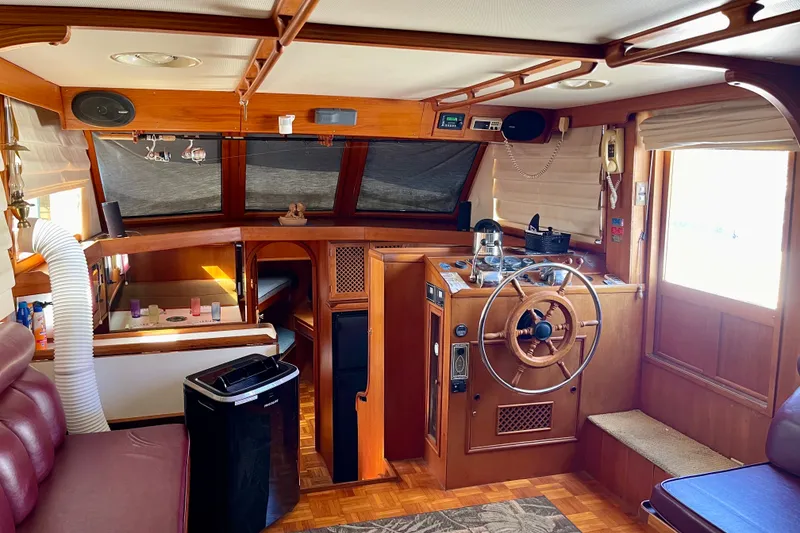 Slide: The Image of Interior of a 1985 CHB 42 boat with wooden helm and cozy seating area. - 28
