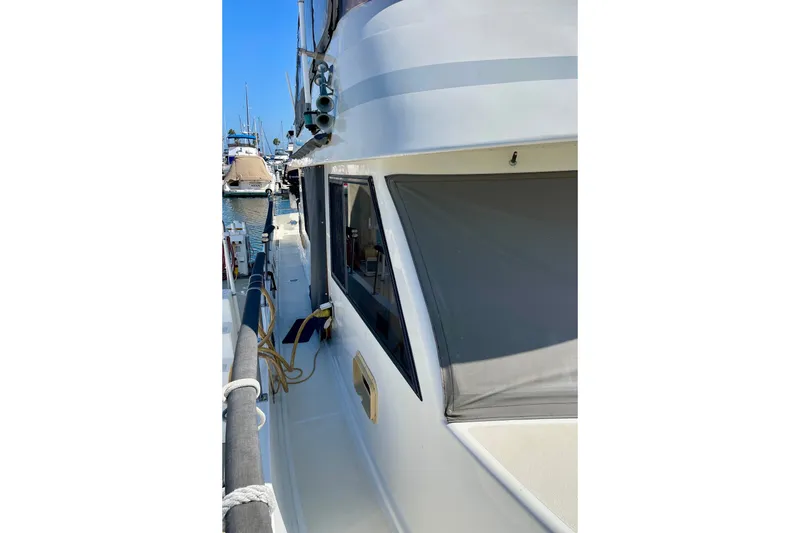 Slide: The Image of 1985 CHB 42 boat docked at marina, side view with clear blue sky. - 6