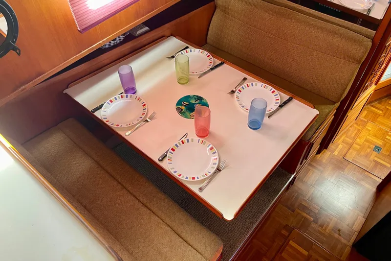 Slide: The Image of Dining area in a 1985 CHB 42 boat with set table and colorful glasses. - 37